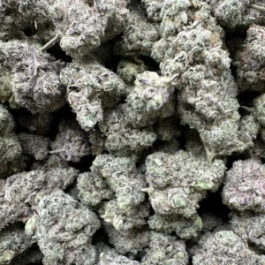 El guapo Greenleaf flower macro shot showing dense frosty buds with heavy silvery-white trichome coverage and tight calyx structure