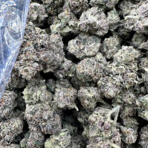 Gushers Greenleaf hybrid flower macro showing densely frosted buds with thick white trichome coverage and tight calyx structure