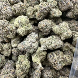 Versace Runtz Zkittles Flower close-up showing dense, frosted buds with lime-green and brown tones and heavy trichome coverage